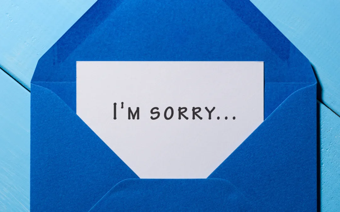 I'm SORRY - message in blue envelope at wooden background